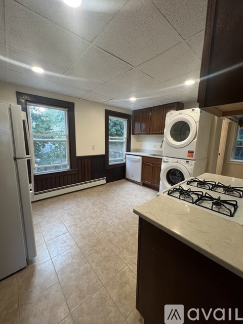 A kitchen with a white refrigerator and a white washing machine.