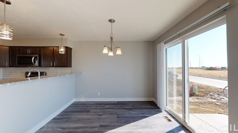 A kitchen area with a counter and cabinets.