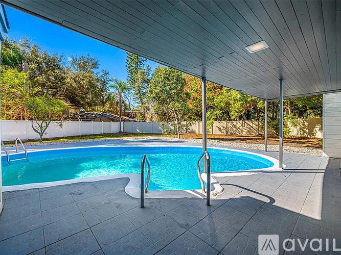 A pool with a metal ladder and a roof.