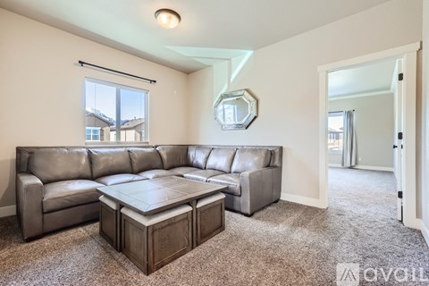 A living room with a grey sofa and a coffee table.