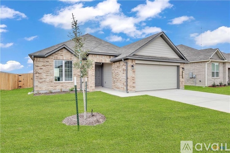 A house with a stone exterior and a grey roof is for sale.