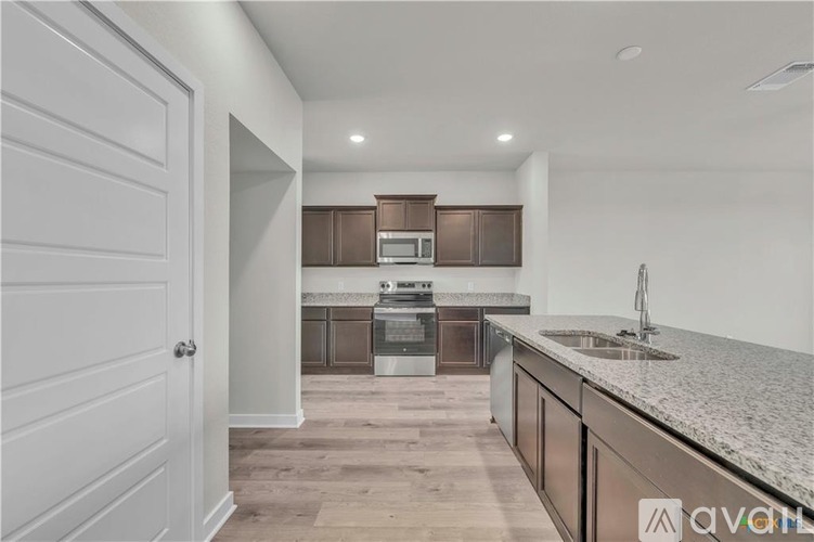 A kitchen with a white door and a countertop.