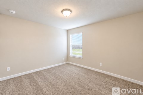 A spacious room with a ceiling fan and lighting fixtures.