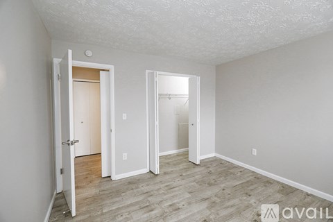 A room with two doors and a wooden floor.