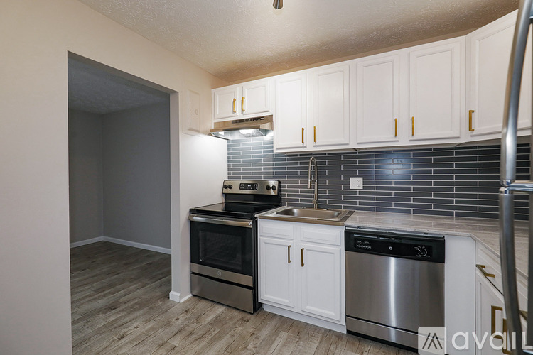 A kitchen with white cabinets and stainless steel appliances.