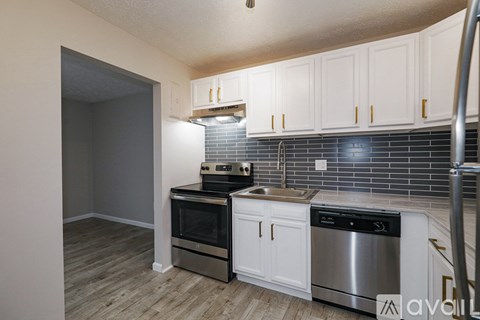 A kitchen with white cabinets and stainless steel appliances.