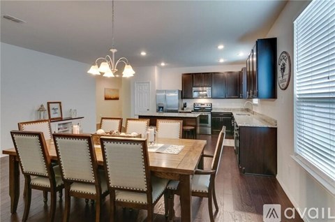 A dining room with a wooden table and chairs.