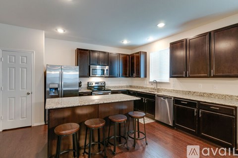 A kitchen with dark wood cabinets and a white door.
