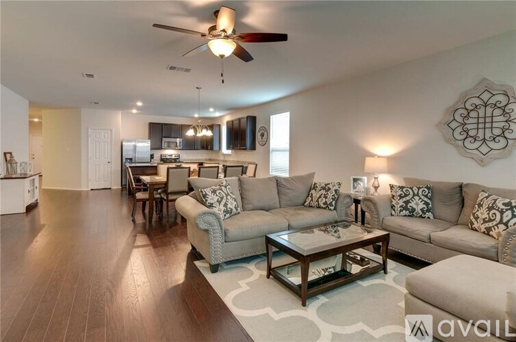 A living room with a grey couch and a coffee table.