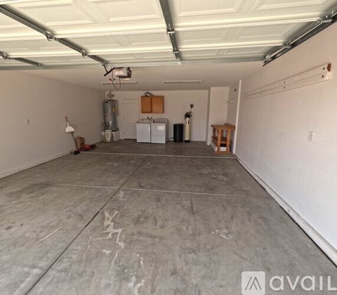 A spacious garage with a concrete floor and white walls.
