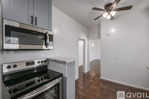 A kitchen with a stove top oven and microwave.
