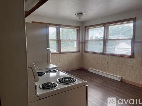 A kitchen with a stove and a window.