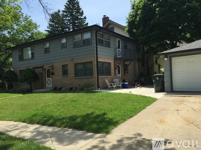 A two-story house with a garage on the right side.