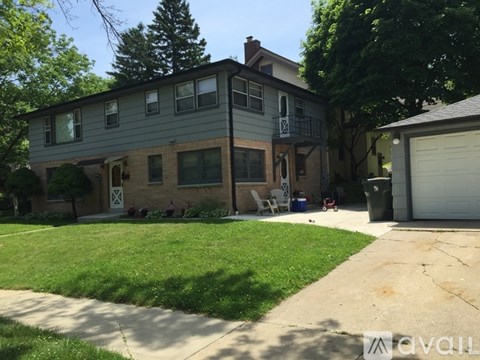 A two-story house with a garage on the right side.