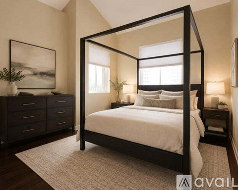 A bedroom with a four-poster bed, a dresser, and a painting on the wall.
