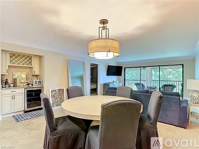 A dining room with a round table and chairs.