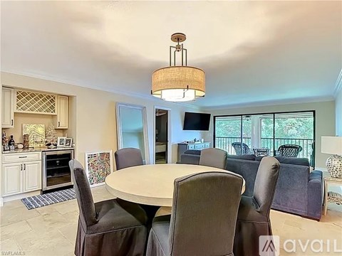 A dining room with a round table and chairs.