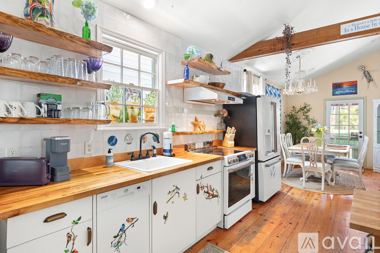 A kitchen with wooden cabinets and a wooden counter top.