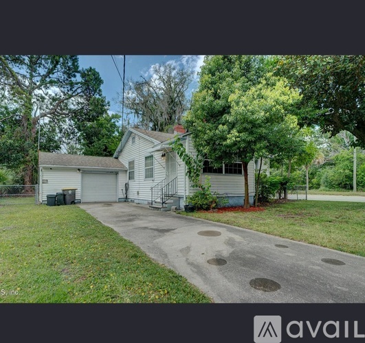 A house with a driveway and a garage is for sale.