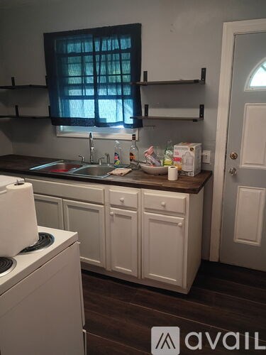 A small kitchen with white appliances and cabinets.