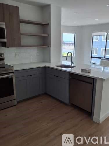 A kitchen with wooden floors and a white countertop.