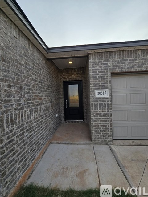 The image shows a house entrance with a number 20517 on the wall.