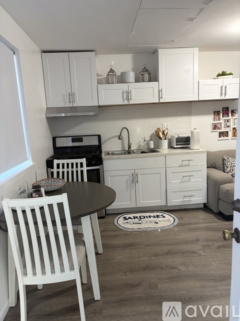 A kitchen with a table and chairs in front of a stove.