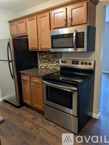 A kitchen with wooden cabinets and stainless steel appliances.