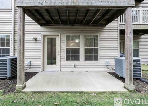A house with a covered entrance has a window and a door.