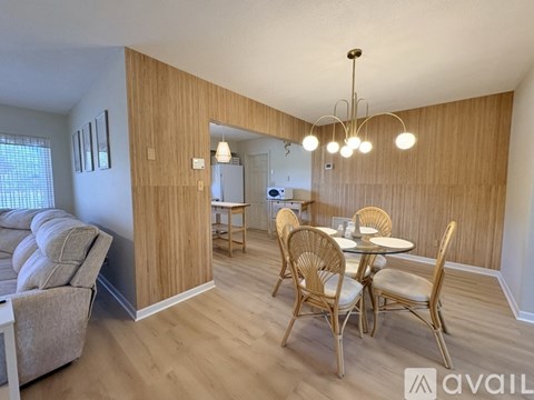 A dining area with a table and chairs is shown.