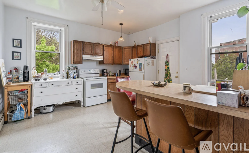A kitchen with a table and chairs in front of it.