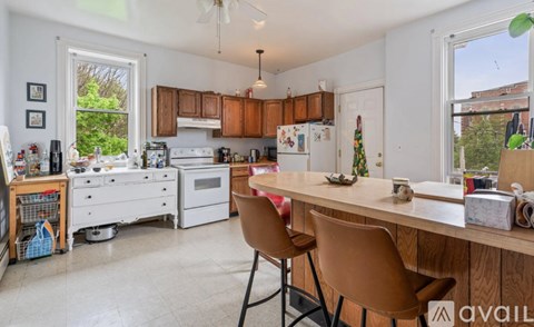 A kitchen with a table and chairs in front of it.