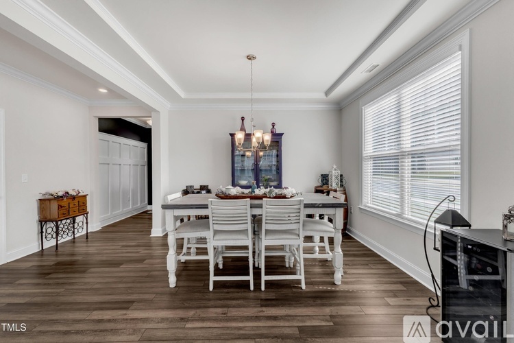 A dining room with a wooden table and chairs.