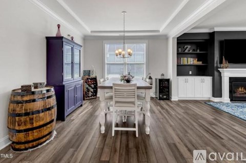 A living room with a white chair and a wooden floor.