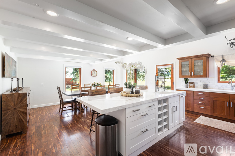 A kitchen with white cabinets and a large island.