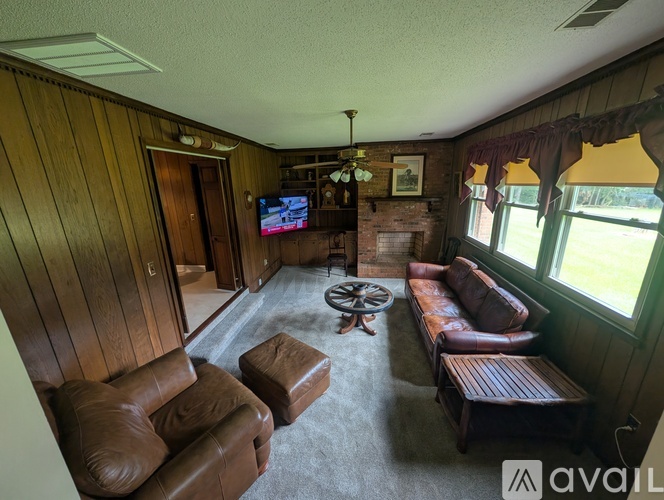 A living room with a flat screen TV and a fireplace.