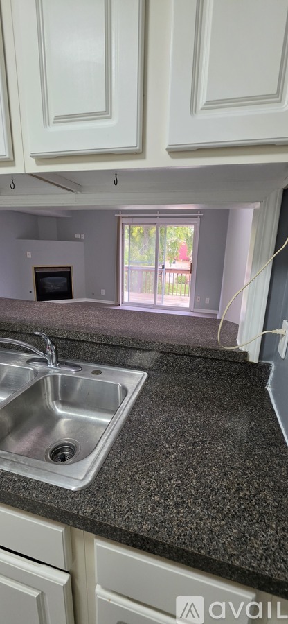 A kitchen with granite countertops and white cabinets.
