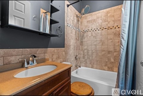A bathroom with a sink, toilet, and bathtub.