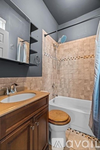 A bathroom with a sink, toilet, and bathtub.