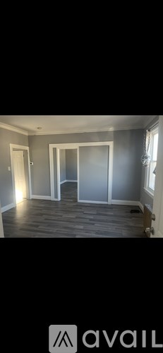 A room with grey walls and wooden flooring.
