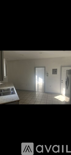 A room with a white door and a white wall.