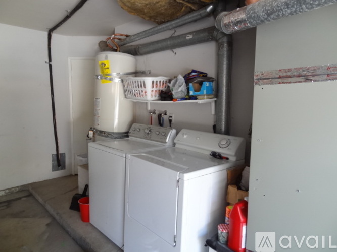 A small laundry room with a washer and dryer.
