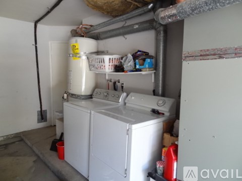 A small laundry room with a washer and dryer.