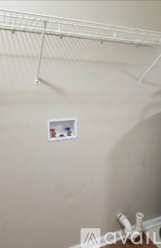 A white shelf with a few items on it.