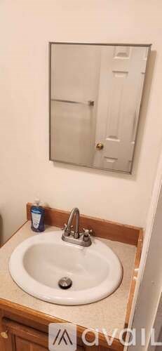 A bathroom with a sink and a mirror.