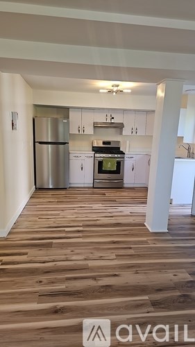 A room with wooden flooring and a ceiling fan.