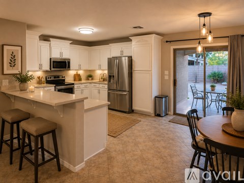 A kitchen with white cabinets and a refrigerator.