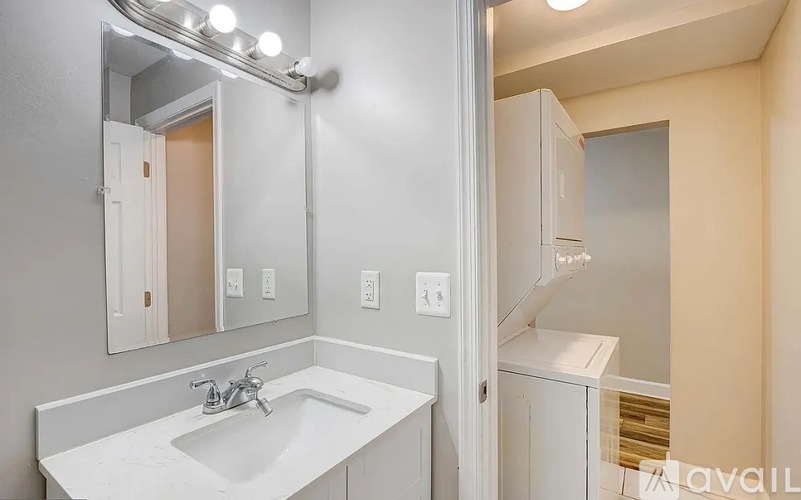 A bathroom with a sink, mirror, and medicine cabinet.