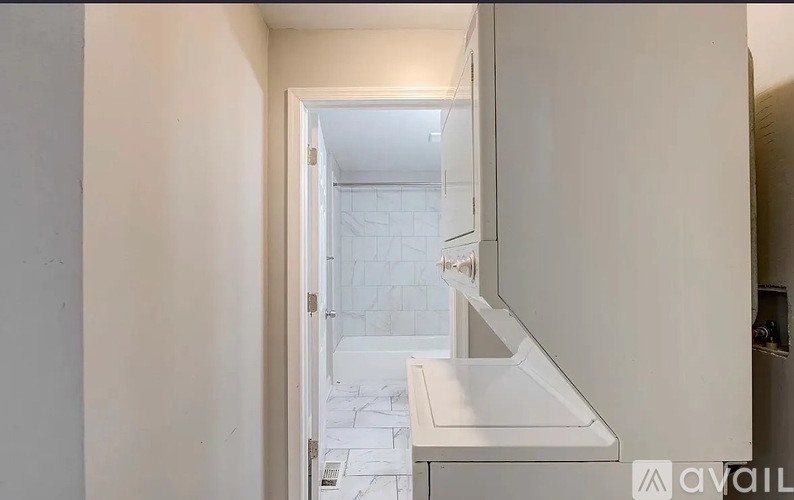 A white bathroom with a sink and a mirror.
