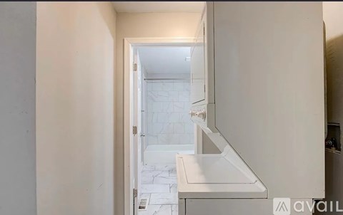 A white bathroom with a sink and a mirror.